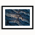 Framed desert landscape artwork with a black mat, showcasing vibrant hues of orange and yellow against a serene blue sky, ideal for modern home decor.