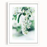 Abstract art print depicting spring with vibrant green and soft pink tones on a white framed canvas.