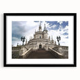 Black-framed landscape artwork showcasing a majestic castle surrounded by lush greenery, complemented by a white mat, ideal for home decor or gallery displays.