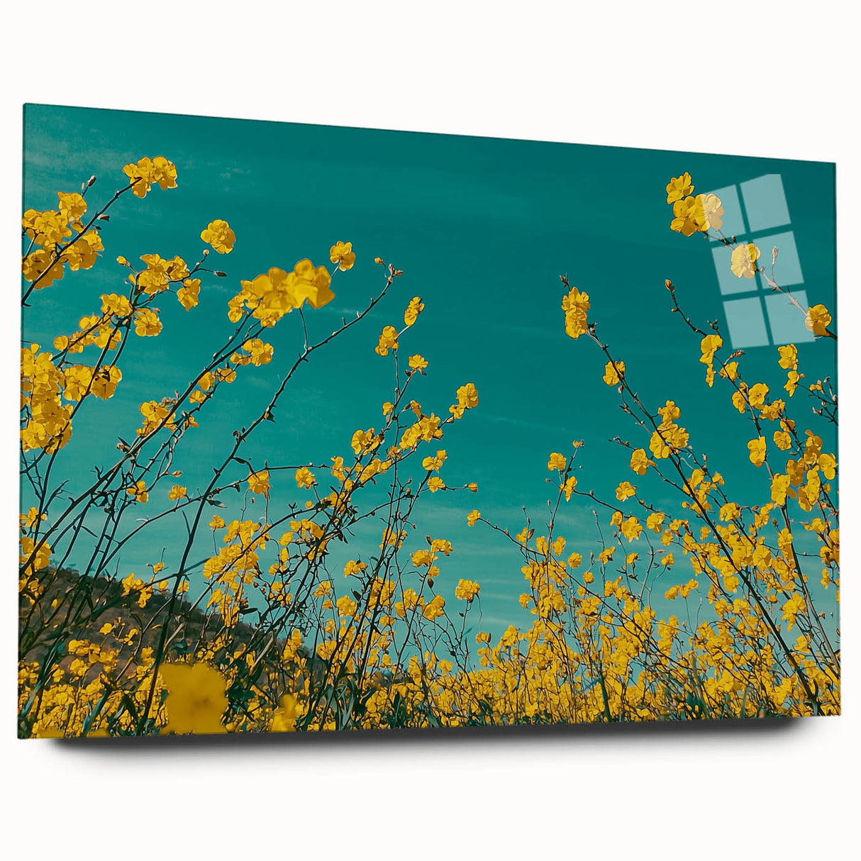 Acrylic landscape artwork depicting a serene countryside scene, presented in a glass frame. The vibrant colors capture lush green fields and a clear blue sky, ideal for home decor.