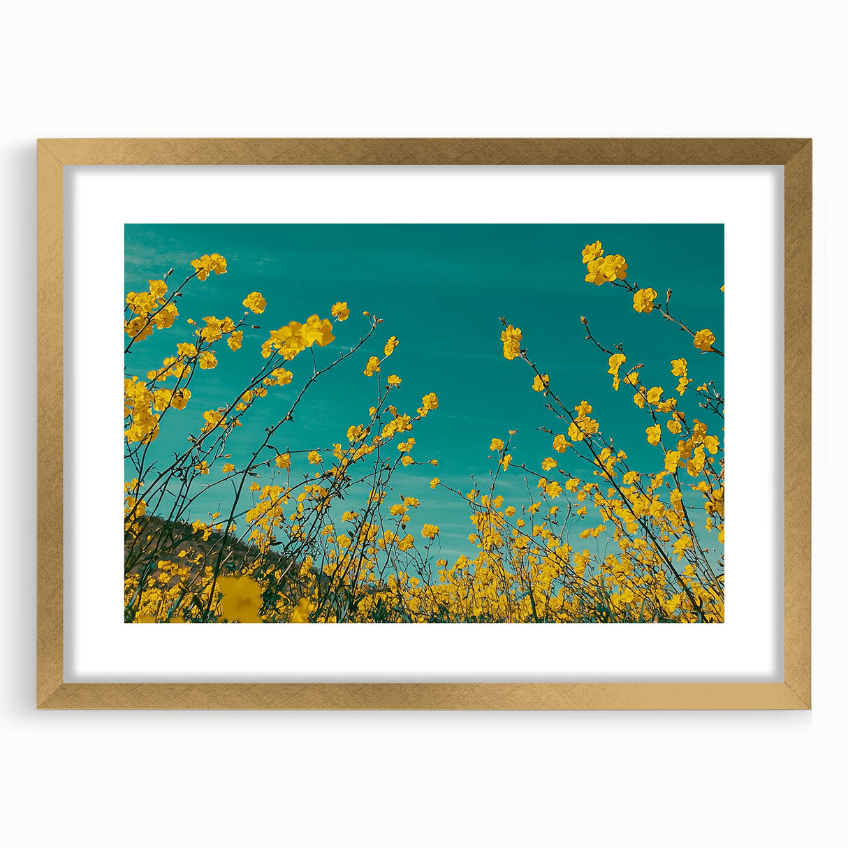 Elegant gold-framed landscape artwork depicting a serene countryside scene with lush greenery and rolling hills, ideal for enhancing home decor.
