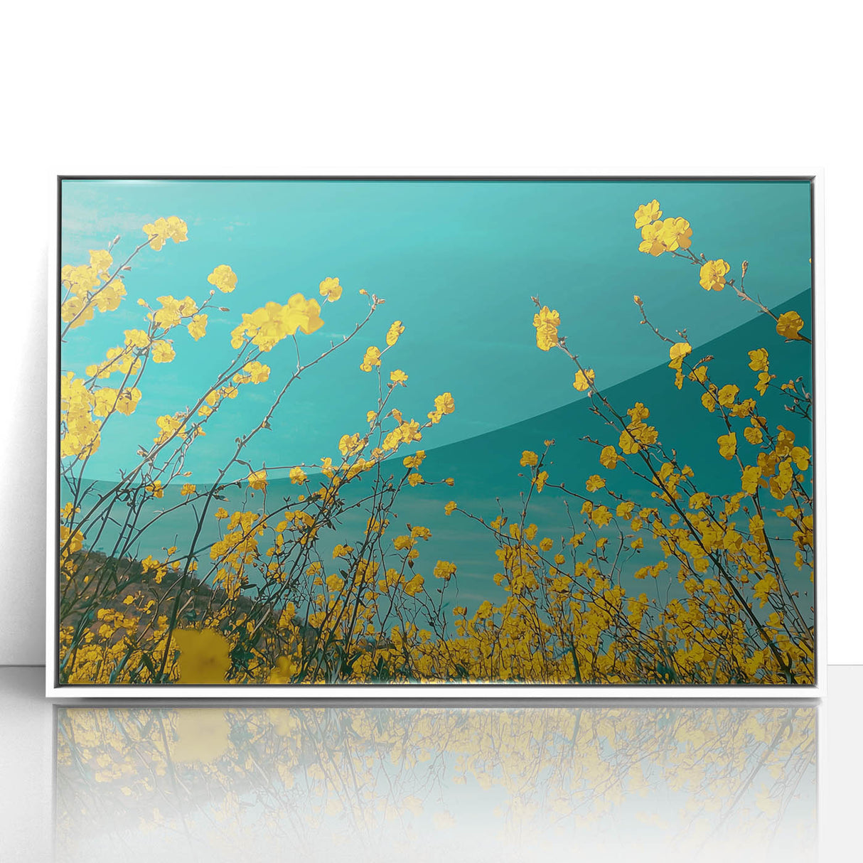 Framed acrylic landscape artwork depicting a serene countryside scene with lush green fields and a clear blue sky, presented in a sleek white frame, ideal for home decor.