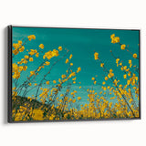 Framed canvas artwork showcasing a serene countryside landscape, featuring vibrant green fields and a clear blue sky, presented in a sleek black frame, ideal for home decor.