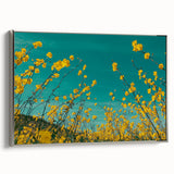Framed canvas artwork showcasing a serene countryside landscape with vibrant green fields and a clear blue sky, elegantly bordered with a silver frame, perfect for home decor.