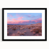 Desert landscape framed artwork in a black frame with a white mat, showcasing vibrant hues of orange and blue, perfect for modern home decor.