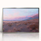 Framed acrylic artwork depicting a serene desert landscape with vibrant orange and gold hues, showcasing the sun setting over distant mountains. Ideal for modern home decor.