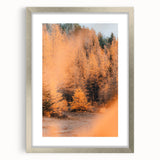 Textured abstract art print depicting fall foliage in orange and brown tones on a silver-framed canvas.