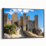 Framed canvas artwork showcasing a picturesque landscape with a majestic castle, presented in a sleek black frame, emphasizing intricate details and vibrant colors.