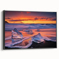 Framed canvas artwork depicting a serene beach landscape at sunset, featuring vibrant blues and warm golds, with a sleek black frame enhancing its elegance. Ideal for adding a tranquil touch to home decor.
