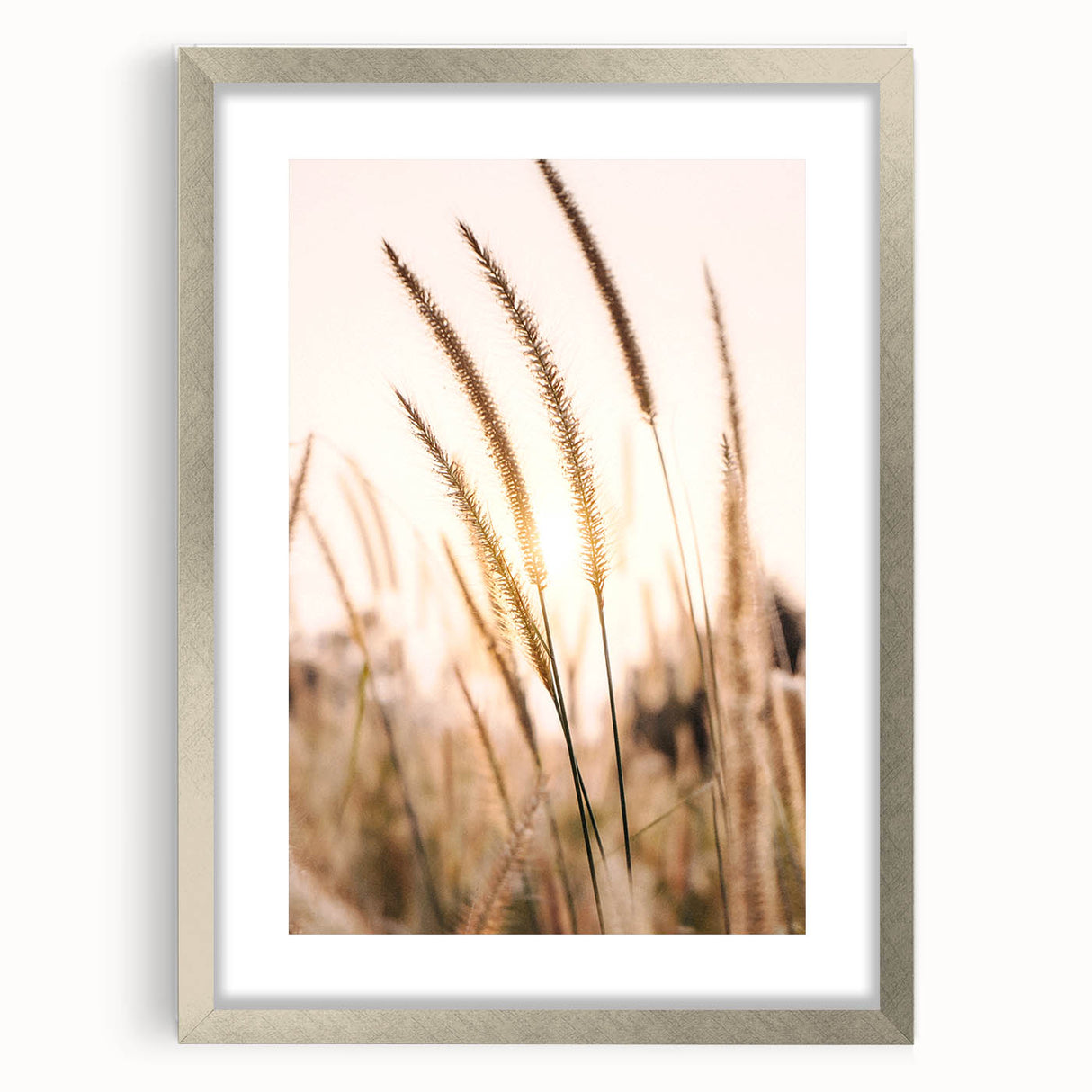Abstract textured art print in warm orange and yellow tones, framed in silver, suitable for bedroom decor.