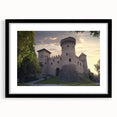 Elegant black-framed landscape artwork showcasing a majestic castle surrounded by lush greenery, presented with a white mat for a refined look. Perfect for enhancing home decor with a classic touch.