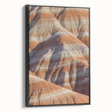 Framed canvas artwork depicting a stunning cliffside landscape, featuring rich colors and intricate details, set against a sleek black frame for modern decor.