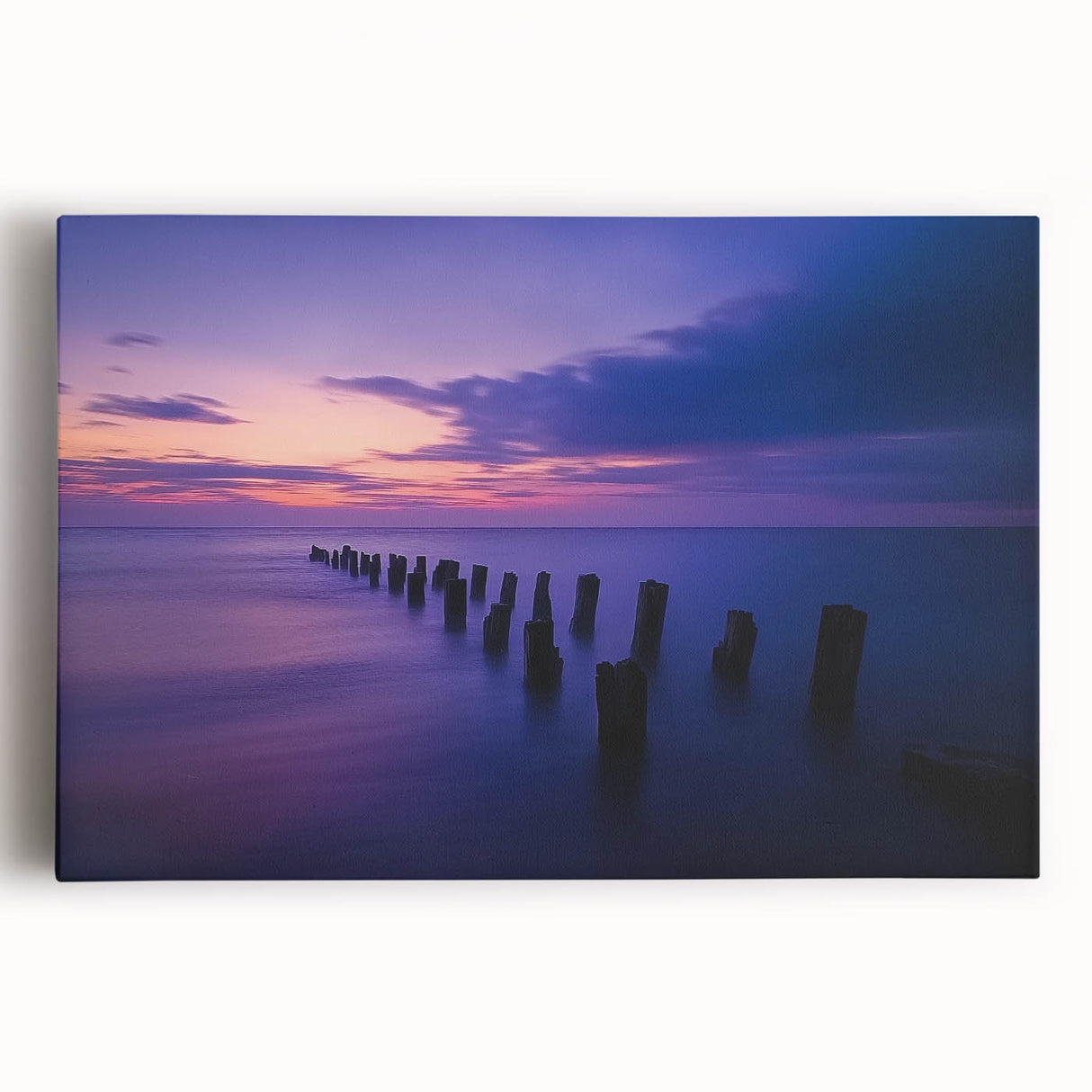 Stretched canvas artwork depicting a serene beach landscape at sunset, featuring vibrant colors and gentle waves, ideal for coastal decor in homes or offices.