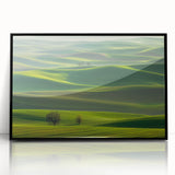 Framed acrylic artwork showcasing a serene countryside landscape with vibrant green fields and blue skies, displayed in a sleek black frame, adding elegance to home decor.