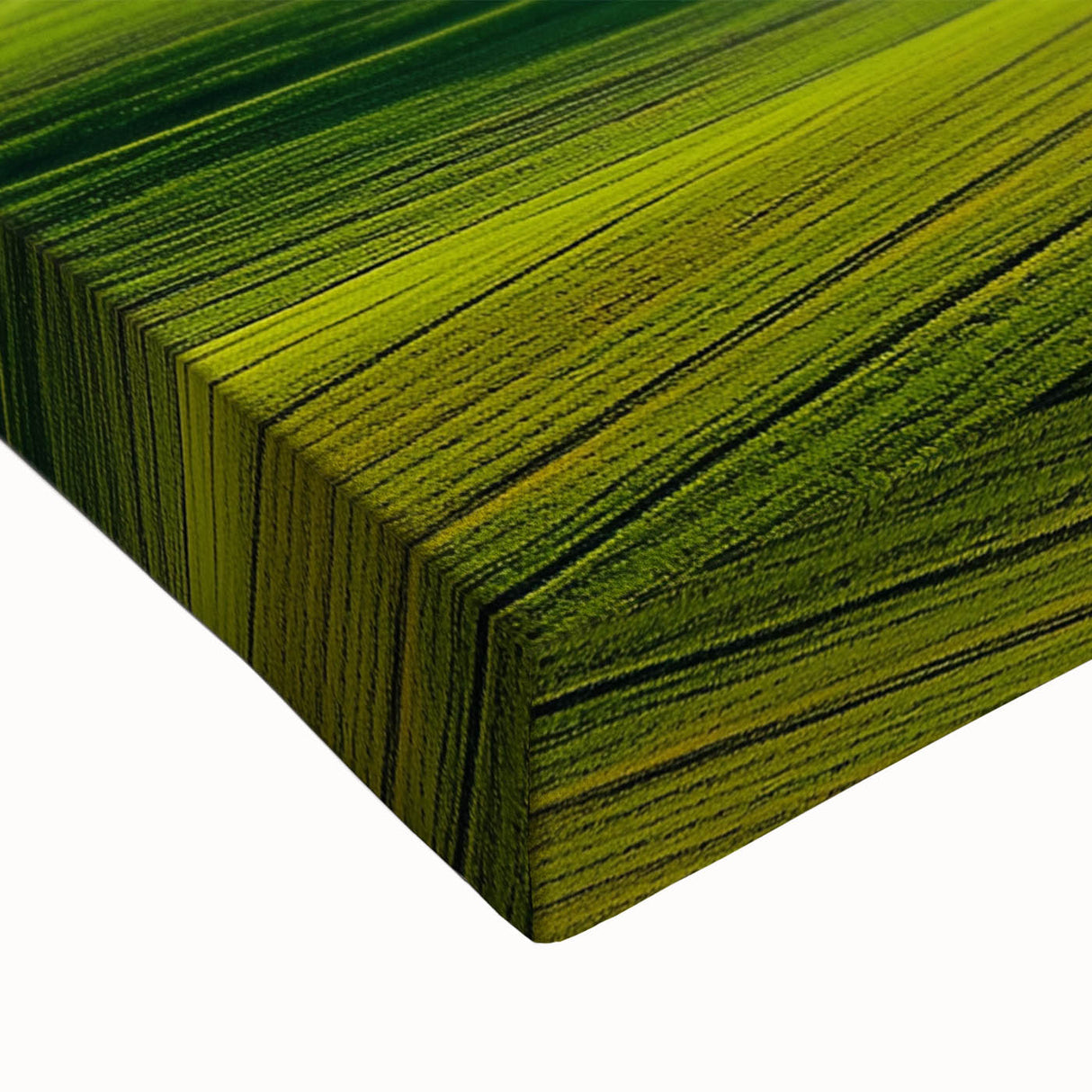 Close-up of a stretched canvas print showcasing a vibrant countryside landscape, featuring rolling hills, lush greenery, and a bright blue sky, perfect for enhancing home decor.