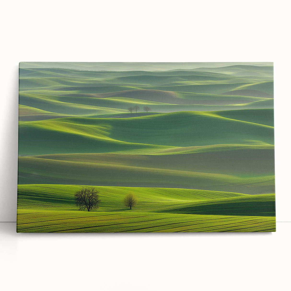 Stretched canvas print showcasing a serene countryside landscape with lush green fields and a clear blue sky, leaning against a rustic wall, perfect for home decor.