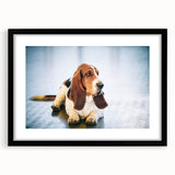 Basset Hound wall art design framed in black, featuring a playful basset hound illustration with a white mat, ideal for dog lovers' home decor. Perfect for adding a touch of charm to any room.