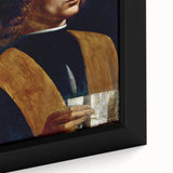 Close-up of a textured black wall art depicting Leonardo da Vinci, with colorful accents on a framed canvas.
