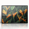 Framed wall art featuring a vibrant Bird of Paradise design in botanical style, showcasing rich greens and bold oranges, ideal for modern home decor.