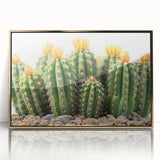 Framed wall art featuring a botanical cactus design in vibrant colors, with a sleek gold frame, displayed against a neutral backdrop, ideal for modern decor.