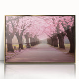 Framed wall art showcasing a botanical cherry blossom design, featuring delicate pink flowers with green leaves, set in an elegant gold frame, perfect for home decor.