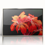 Framed wall art featuring a botanical geranium design in vibrant colors, enclosed in a sleek silver frame with acrylic front, ideal for home decor.