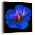 Framed wall art showcasing a vibrant hibiscus floral design in silver and gold tones, ideal for home decor or botanical-themed interiors. The canvas adds elegance and color to any room.