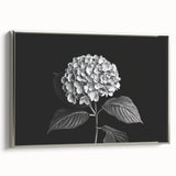 Framed wall art featuring a botanical hydrangea design on canvas, showcasing vibrant blue and green hues, elegantly set in a silver frame for a modern decor style.