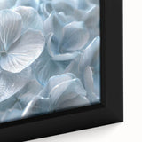 Close-up of a framed botanical wall art piece showcasing vibrant blue and purple hydrangeas on a textured canvas, perfect for home decor and floral enthusiasts.