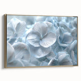 Framed canvas wall art showcasing a botanical hydrangea design in soft blue and white hues, elegantly presented with a gold frame, perfect for home decor.