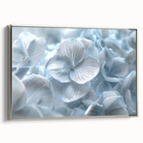 Framed canvas wall art showcasing an elegant hydrangea botanical design in soft blue and white hues, featuring a sleek silver frame, ideal for home decor.