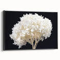 Framed canvas wall art featuring a botanical design of hydrangeas in soft pastel colors, presented in a sleek black frame, ideal for home decor.