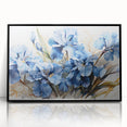 Framed wall art featuring a botanical design of vibrant irises in shades of blue and purple, set against a sleek black frame for modern decor enhancement.
