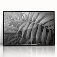 Framed wall art featuring a botanical design of colorful flowers and leaves on a black background, showcasing vibrant colors and intricate details, perfect for home decor.