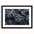 Botanical wall art print showcasing a vibrant monstera leaf design in a black frame with matting, perfect for home decor and nature enthusiasts.