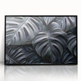 Framed wall art featuring a botanical monstera design, showcasing vibrant green leaves on a sleek black background, ideal for modern home decor.