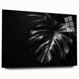 Acrylic glass wall art featuring a vibrant botanical Monstera design, showcasing lush green leaves against a clear background. Perfect for modern decor.
