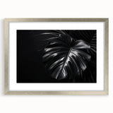 Botanical wall art featuring a vibrant Monstera leaf design in a sleek silver frame with a white mat, perfect for enhancing modern home decor and adding a touch of nature.