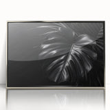Framed botanical wall art featuring a vibrant Monstera plant design, showcased in a sleek silver frame, ideal for modern home decor and nature enthusiasts.