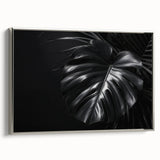 Framed wall art featuring a botanical design of a Monstera plant in vibrant green hues, elegantly displayed against a silver frame, ideal for modern decor.