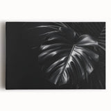 Stretched canvas wall art featuring a vibrant botanical Monstera design, showcasing lush green leaves against a neutral background, perfect for home decor.