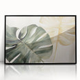 Framed wall art featuring a botanical monstera design on an acrylic surface, showcasing vibrant green leaves against a sleek black frame, ideal for modern home decor.