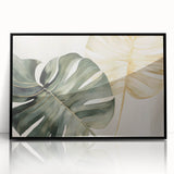 Framed wall art featuring a botanical monstera design on an acrylic surface, showcasing vibrant green leaves against a sleek black frame, ideal for modern home decor.
