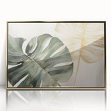 Framed botanical wall art featuring a Monstera leaf design in vibrant green tones, set against a gold acrylic frame, perfect for modern home decor.