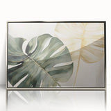 Framed acrylic wall art showcasing a vibrant monstera plant design with a botanical theme, featuring a sleek silver frame, ideal for modern home decor.