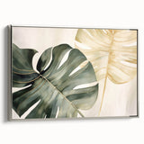 Framed botanical wall art showcasing a vibrant Monstera leaf design with a silver border, ideal for modern home decor. The canvas adds a fresh, tropical vibe to any room.