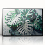 Framed wall art featuring a botanical design of Monstera leaves in vibrant green hues, set against a sleek black background, perfect for modern home decor.