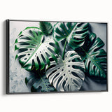Framed botanical wall art featuring a Monstera leaf design on black canvas, showcasing vibrant green hues and elegant lines, perfect for modern decor accents.
