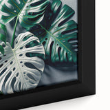 Framed botanical wall art featuring a close-up design of vibrant monstera leaves against a neutral backdrop, ideal for modern decor and nature lovers.