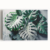 Stretched canvas wall art showcasing a vibrant botanical design featuring a Monstera plant with lush green leaves, perfect for modern home decor.